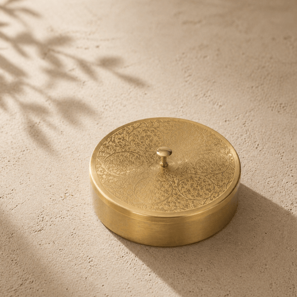 Closed brass masala dabba with flat lid top view