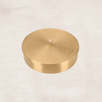 Closed brass masala dabba with flat lid top view