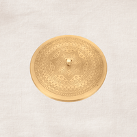 Top view of handcrafted brass spice box lid featuring intricate hammered texture detailing.