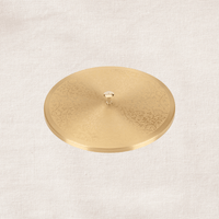 Angled view of engraved brass lid of masala dabba