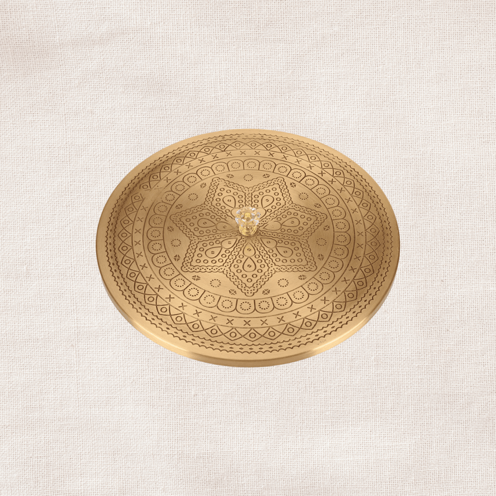 Engraved brass lid of masala dabba close-up