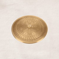 Engraved brass lid of masala dabba close-up